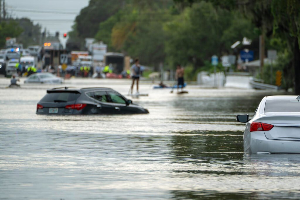 Water flooding a Las Vegas street during a monsoon rainstorm, illustrating flash flood risk for Nevada homeowners.